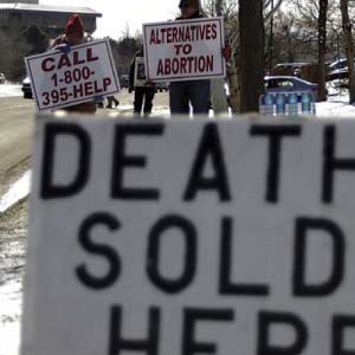 Abortion protestors gather weekly along a street in Lakewood, CO.