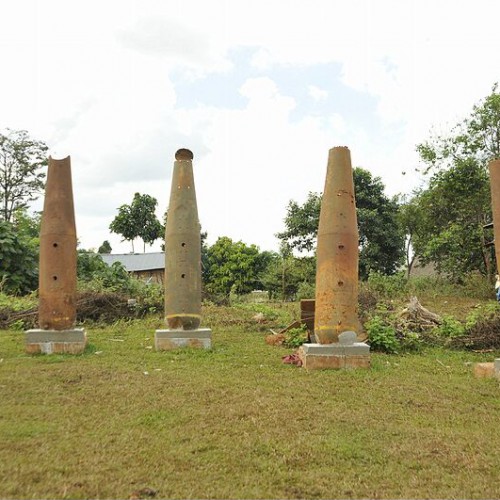 Old US dropped bomb casings from Vietnam War era are on display in one village